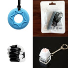 A 2x2 image grid showcasing the 2 Chew Necklaces + 2 Fidget Toys Bundle (choose your colors): a blue silicone chew necklace with a star pattern, a black chewable pendant in packaging, a black and white coil toy, and a Paw Keyboard Fidget Keychain with a paw-shaped button.