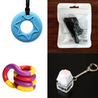 A collage of four items: a blue star-shaped pendant with a hole in the center on a black cord, a sealed plastic package containing an item, a coiled rubber fidget toy in red, yellow, and purple, and a Paw Keyboard Fidget Keychain featuring a white cat paw-shaped button on a clear base can be found in the "2 Chew Necklaces + 2 Fidget Toys Bundle (choose your colors).