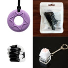 A four-item collage from the 2 Chew Necklaces + 2 Fidget Toys Bundle (choose your colors): a purple circle pendant with a star-shaped hole, a packaged black tool, a black and white coiled ring toy, and a fidget keychain with a white cube featuring a pink paw print on top.