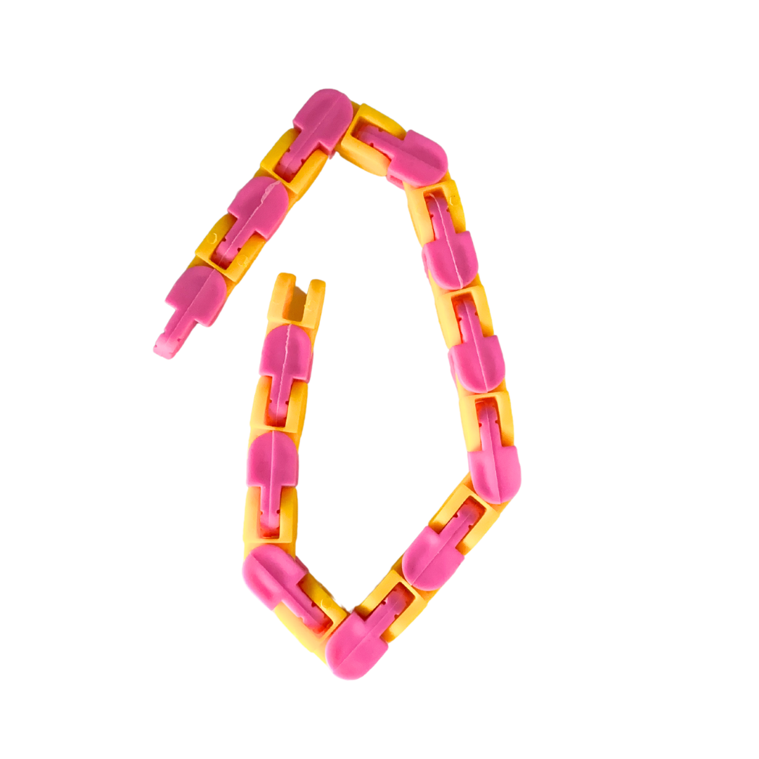 A Snap and Click Fidget Toy chain made of pink and yellow interlocking plastic links is arranged in an incomplete circle shape on a white background.