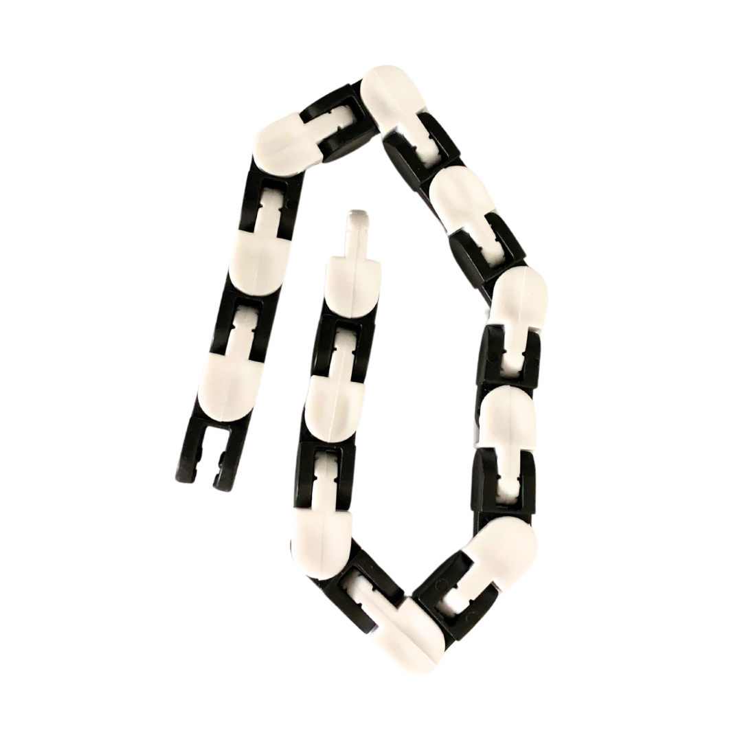 A Snap and Click Fidget Toy made of flexible plastic with interlocking segments arranged in a loose spiral, featuring alternating black and white pieces with a rounded, smooth finish that allows for articulation and movement. Ideal as a stim toy for autistic adults.